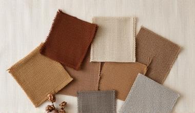 Several fabric swatches showing a range of yellow, brown, and olive hues, neatly arranged.