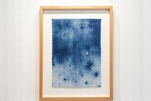 Framed indigo shibori textile art piece, featuring an Arashi pattern