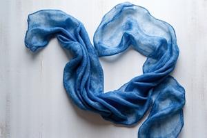 Hand-dyed indigo shibori silk scarf with a soft, flowing pattern